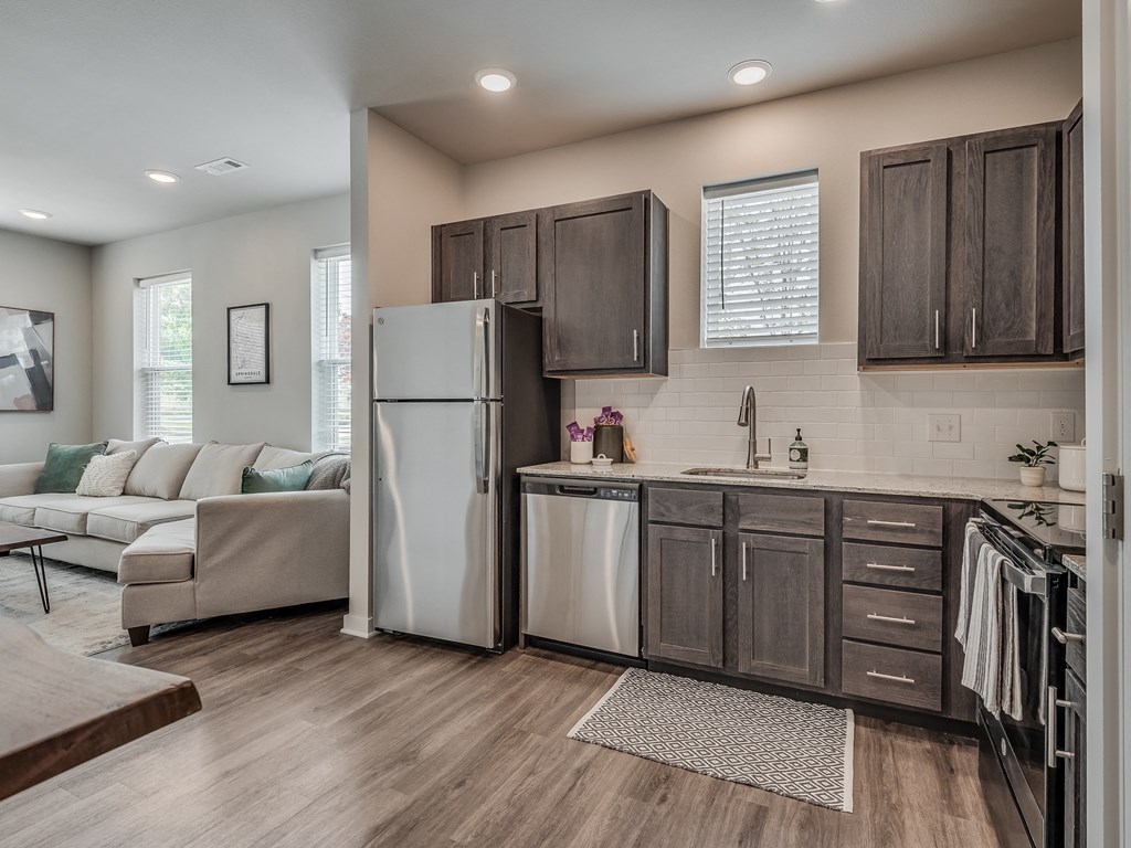 Kitchen with Dark Brown Cabinetry and Stainless Steel Appliances