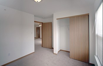 Carpeted Bedroom With Sliding Closet Doors - Photo Gallery 29