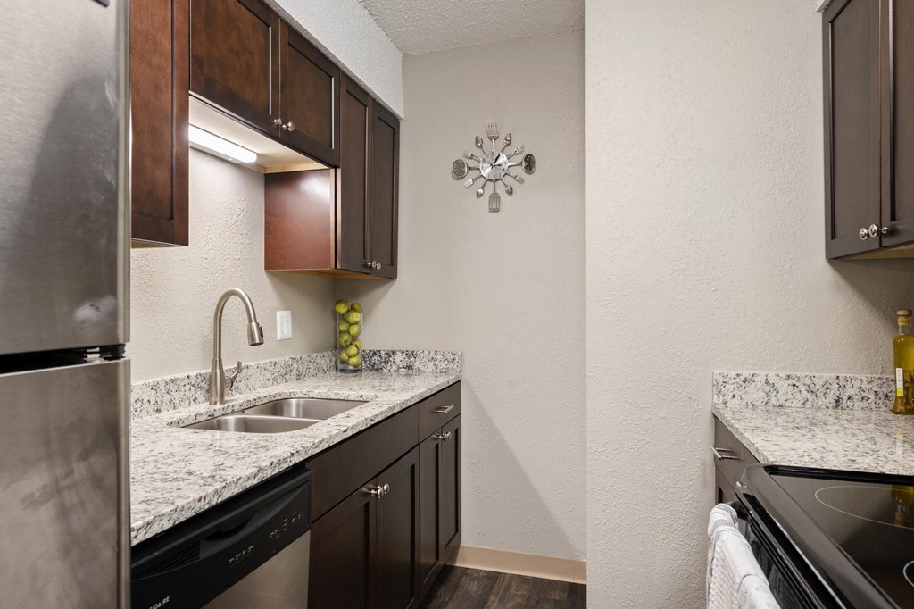 Galley Kitchen With Granite Countertops & Stainless Steel Appliances