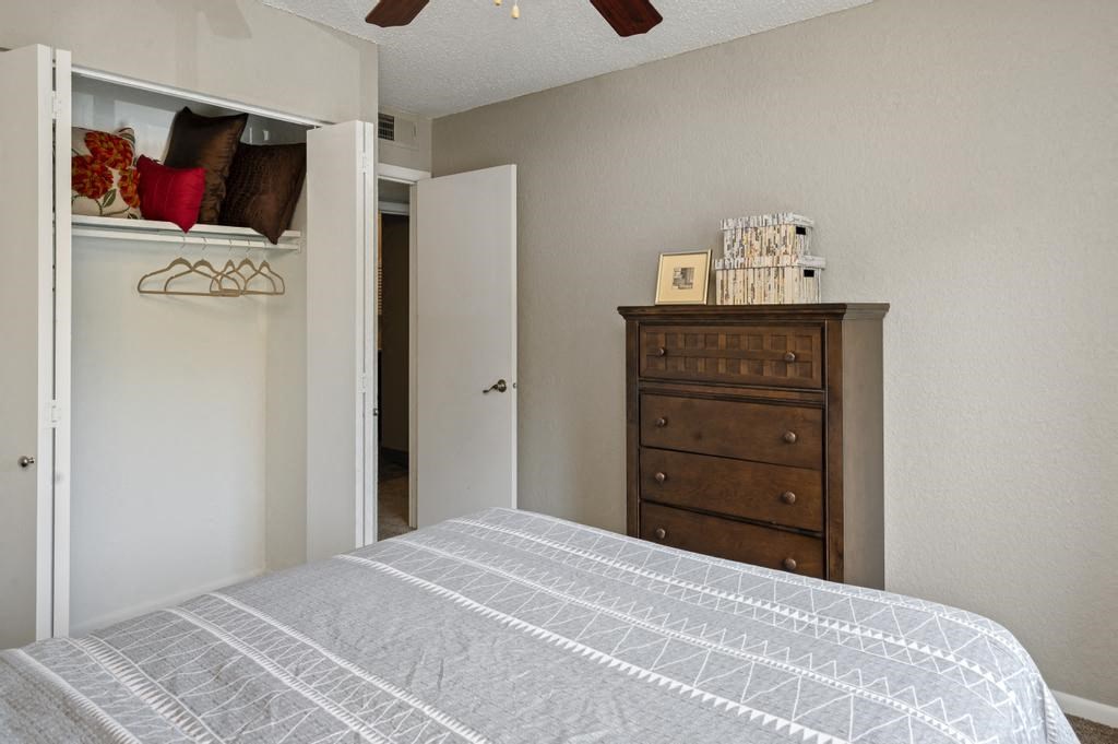 Bedroom With Accordion-Style Closet Doors