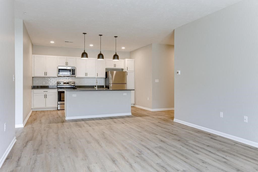 Spacious Living Area With Luxury Vinyl Wood Flooring