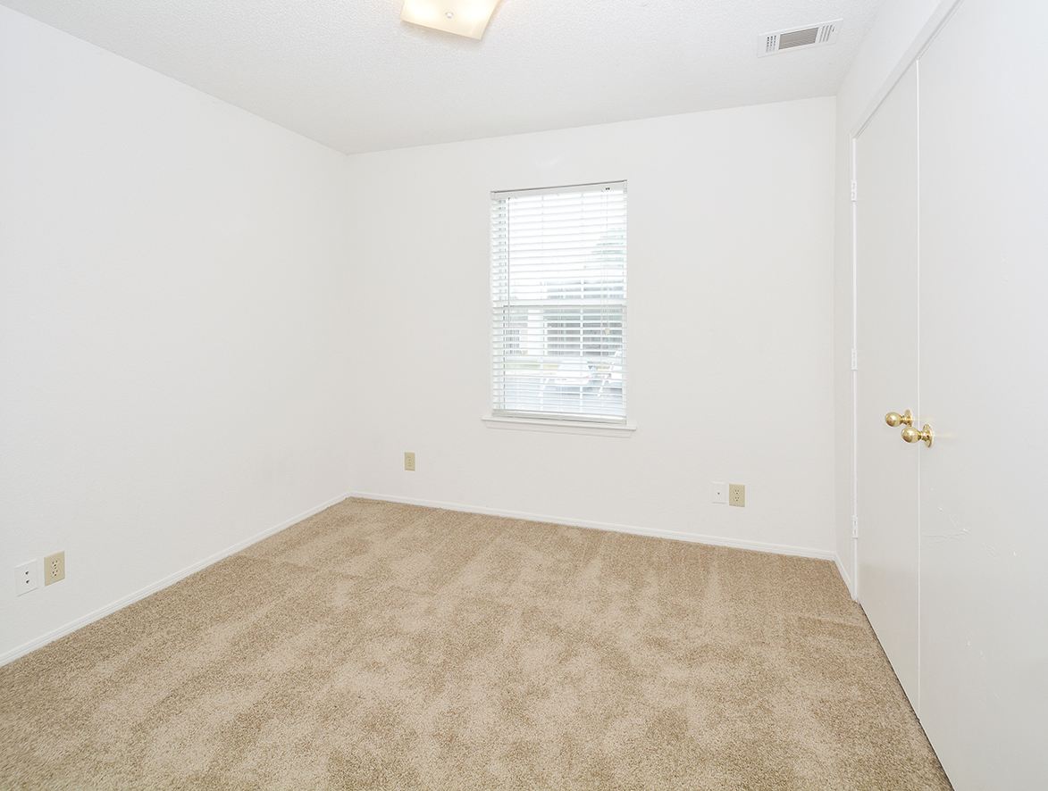 Carpeted Bedroom with Window and Built-In Blinds