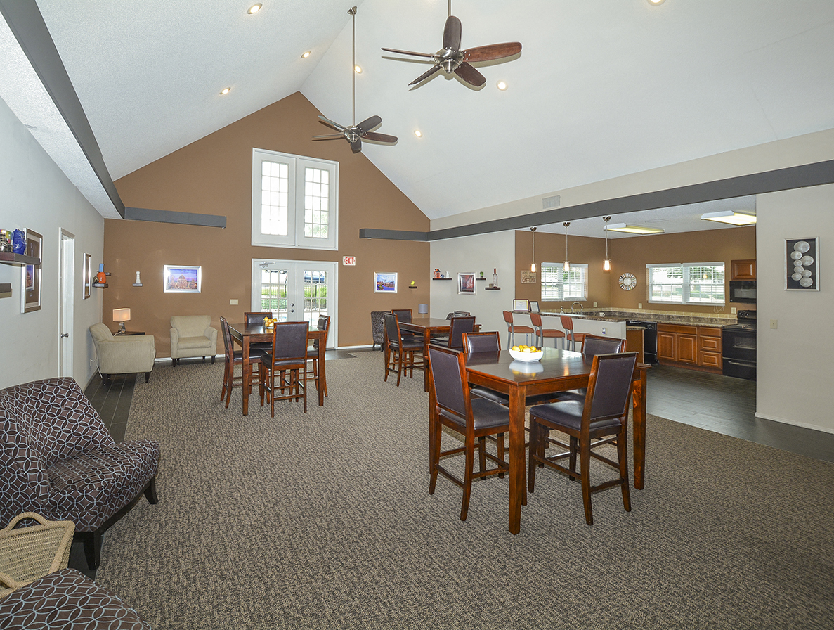 a large living room with a dining table and a kitchen