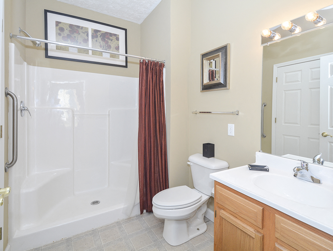 Full Sized Bathroom with  Tile Style Flooring and Walk-In Shower and