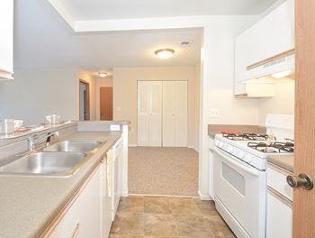 Kitchen with Light Grey Countertops and Tile Style Flooring