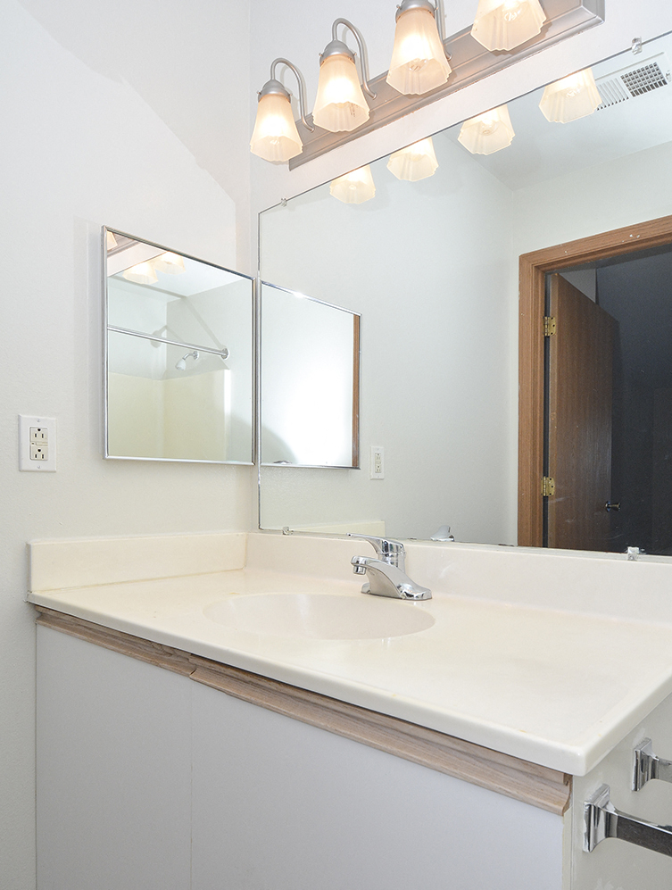 Bathroom with Vanity and Built-In Overhead Lighting