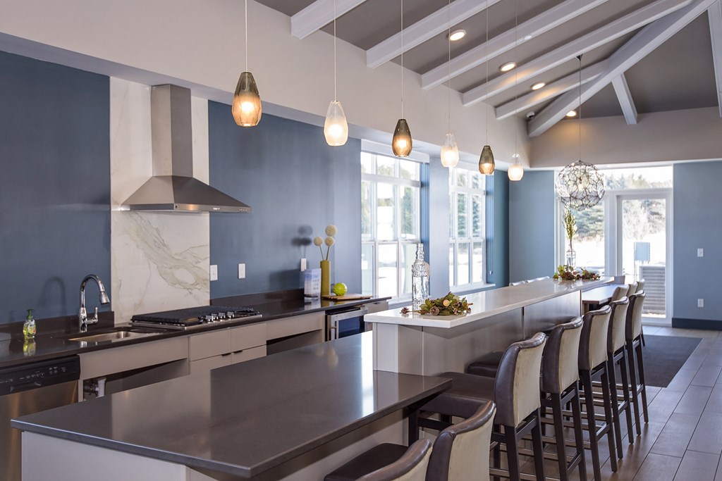 Clubroom Kitchen Area with Expansive Island and Ample Barstool Seating