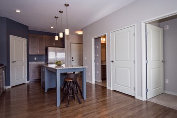 Spacious Open Concept Living with Hardwood Style Flooring and White Trim - Photo Gallery 4
