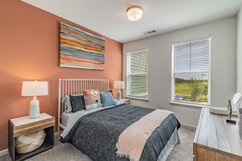 Carpeted Bedroom With Two Large Windows