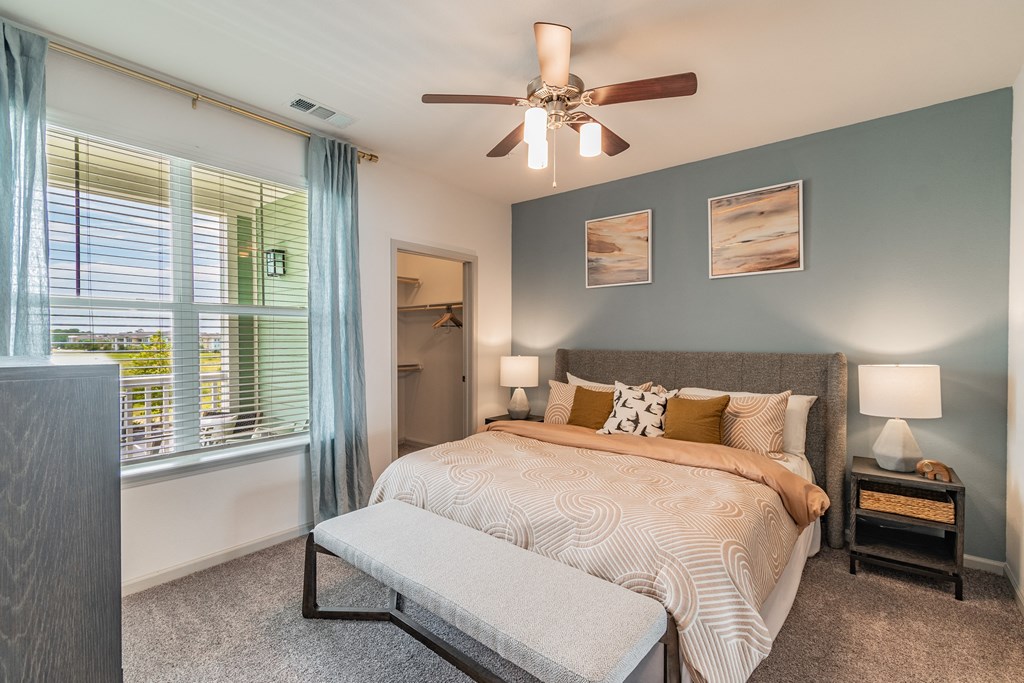 Bedroom With Large Windows & Built-In Window Treatments