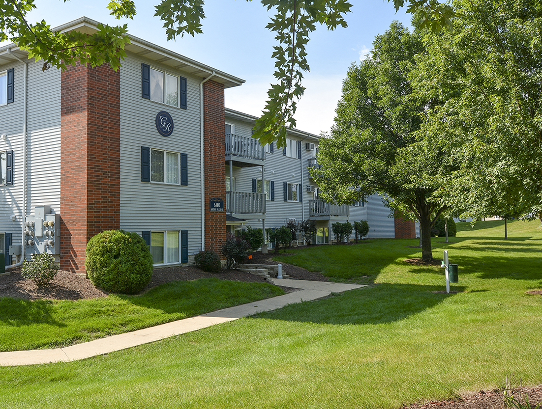 Lush Greenery and Grass in Front of a Grand Ridge Apartment Building