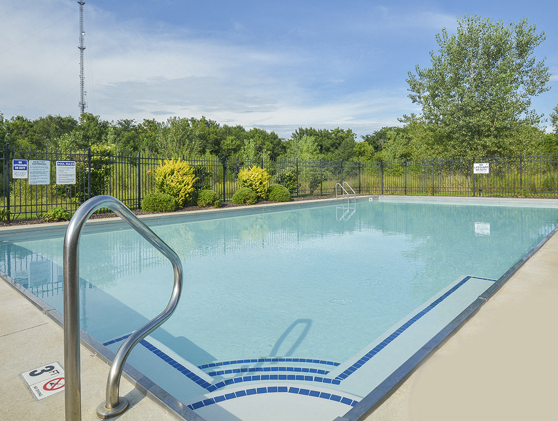 Sparkling Fenced-In Pool Overlooking Lush Greenery