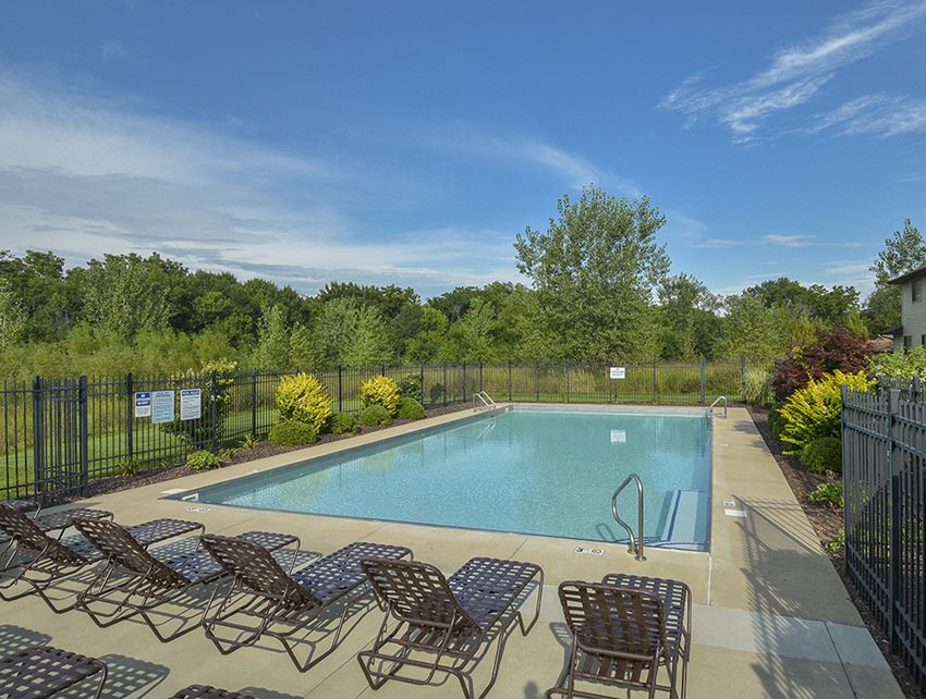 Sparkling Fenced-In Pool and Sundeck with Lounge Chairs - Photo Gallery 1