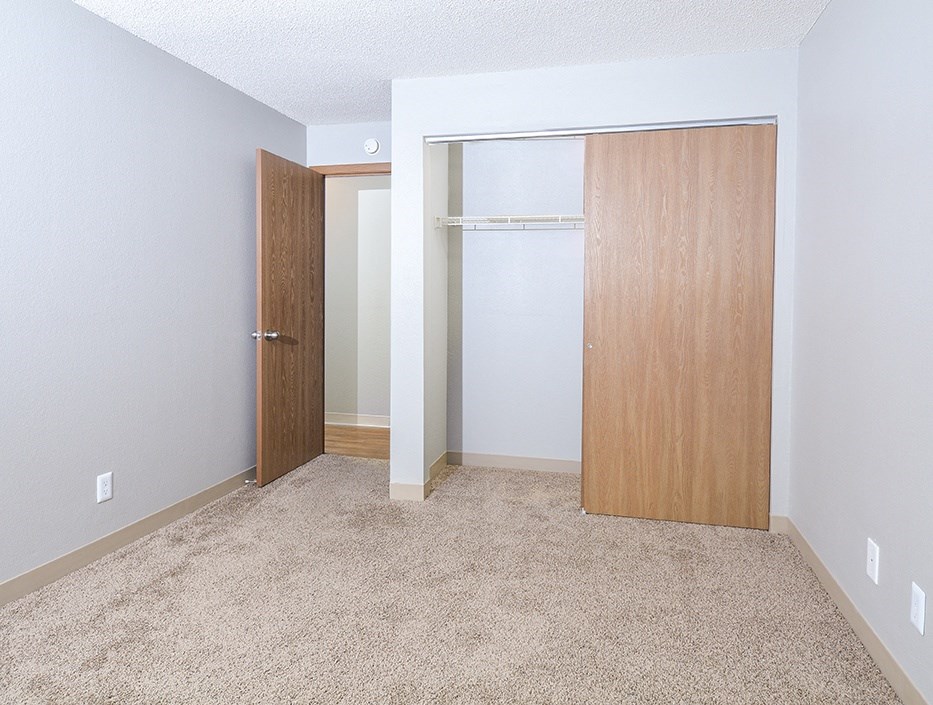 a bedroom with a closet and an open door