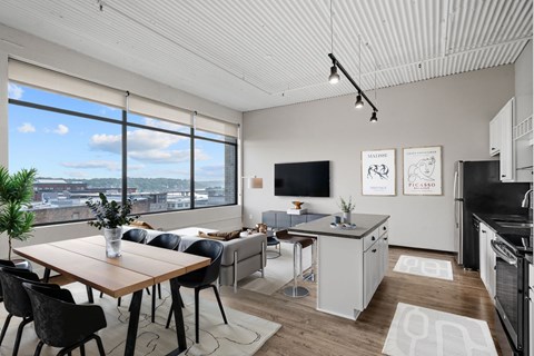 A modern kitchen with a dining table and chairs.