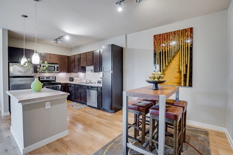 a kitchen with a bar and a dining table