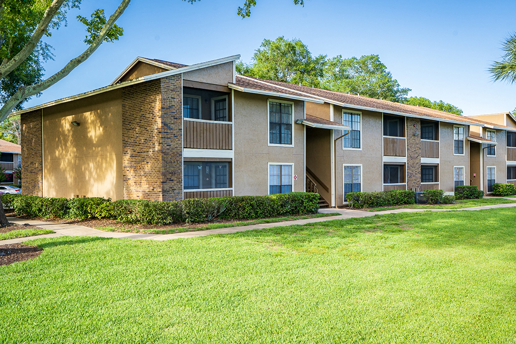 Lush Grass and Green Space in Front of a Forestlake Apartment Building