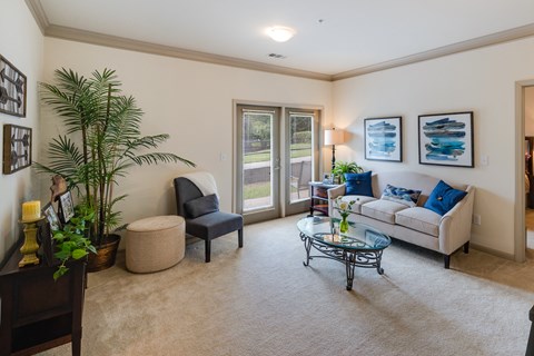 a living room with a couch and a glass coffee table