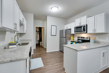 Kitchen With White Cabinetry & Stainless Steel Appliances