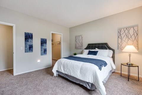 Carpeted Bedroom With Attached Walk-In Closet