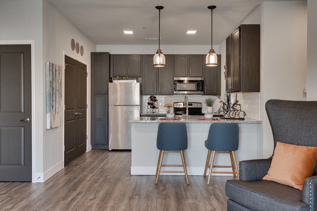 Kitchen With Stainless Steel Appliances & Breakfast Bar