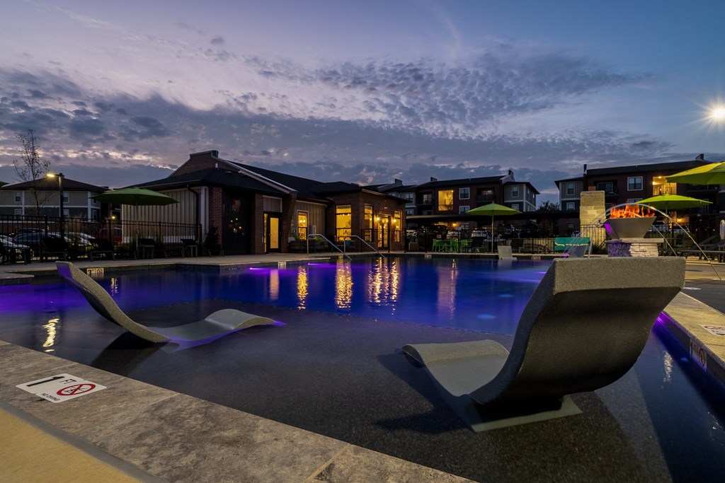 Sun Lounger Chairs In The Pool At Night