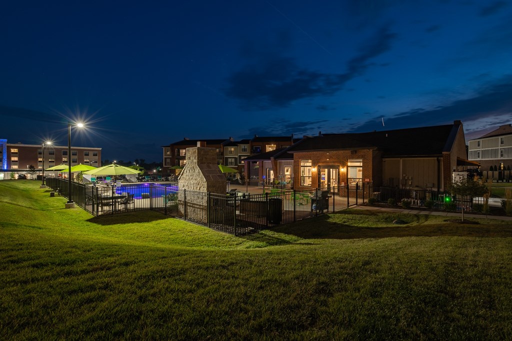Clubhouse Overlooking The Fenced-In Pool & Sundeck At Night