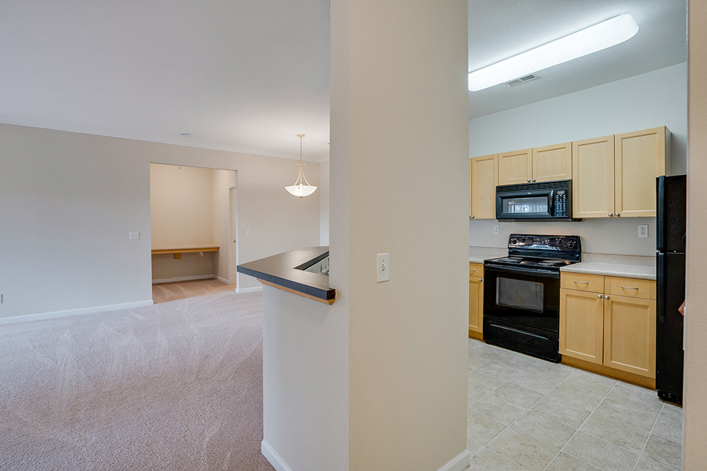 Open Concept Living Room and Kitchen with Built-In Computer Desk