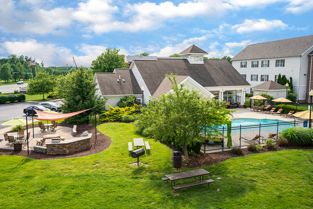 Lush Grass and Landscaping Around the Pool and Grilling Area