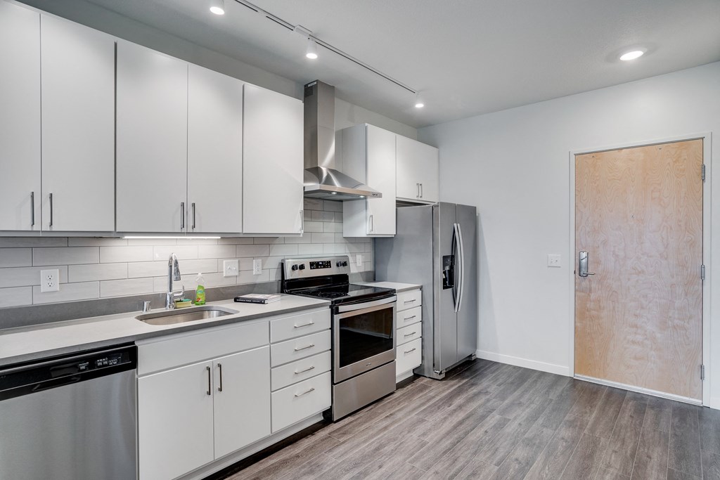 Spacious Kitchen with Grey Hardwood Style Flooring