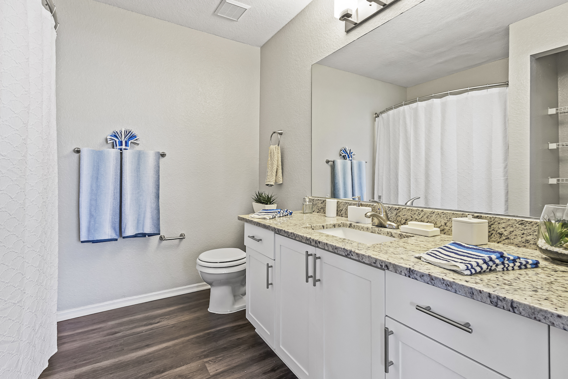 Bathroom with Grey Hardwood Style Flooring with Shower and Tub