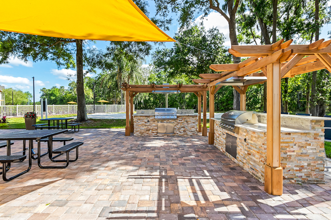 Outdoor Grilling Area with Pergolas and Picnic Tables