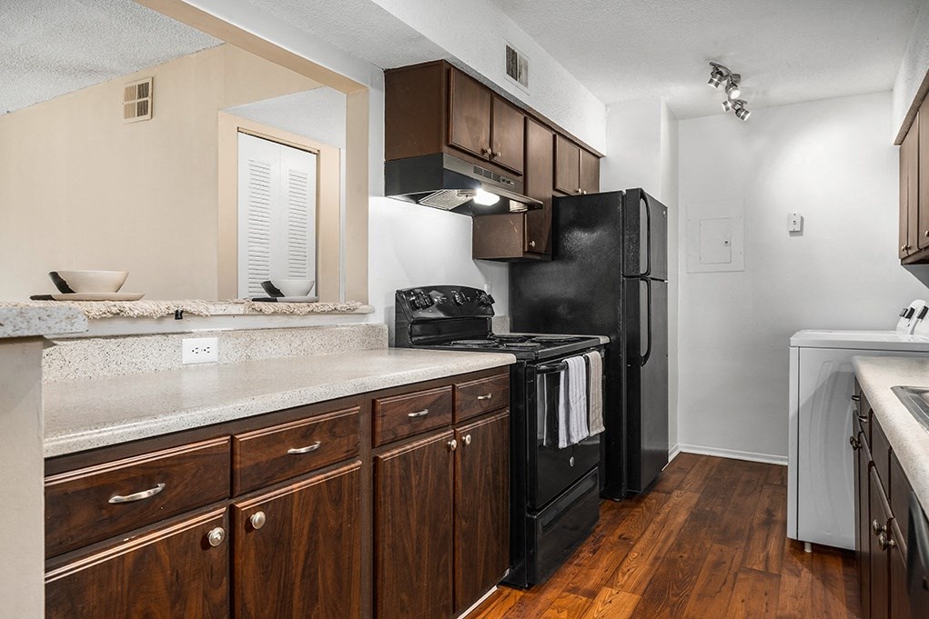 Kitchen With Wood-Style Flooring & Overhead Track Lights
