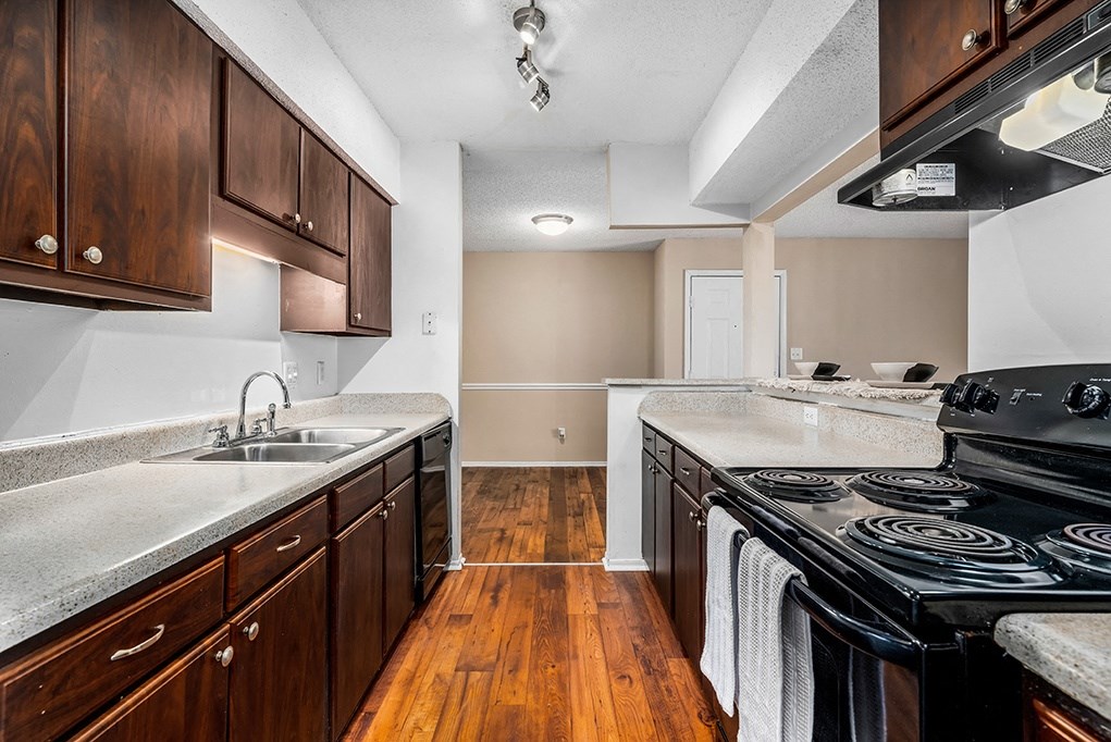 Galley Kitchen With Black Appliances & Espresso Cabinets