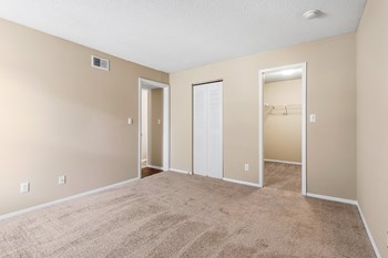 Carpeted Bedroom With Attached Walk-In Closet - Photo Gallery 22