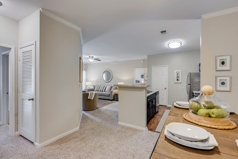 a living room with a dining room table and a kitchen