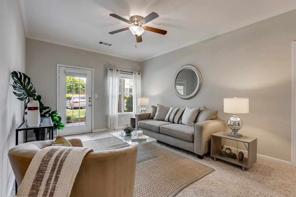 Living Room Featuring Tall Ceilings & Lots Of Natural Light