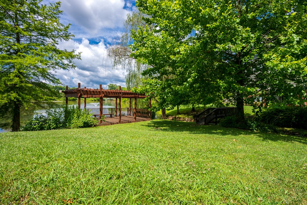 Pergola & Lush Grass Area Overlooking The Pond Area