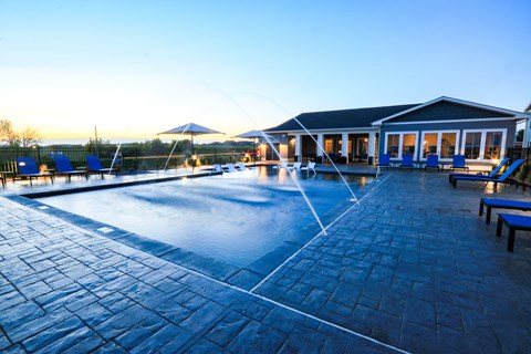 Resort-Style Pool With Fountains At Dusk