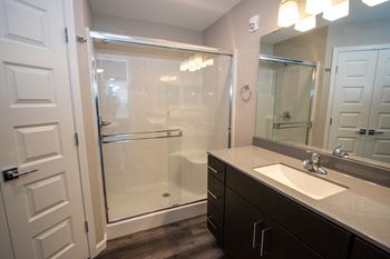 Spacious Bathroom With Glass Sliding Shower Doors