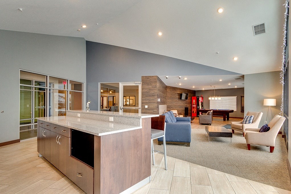 a large living room with a kitchen and a dining room