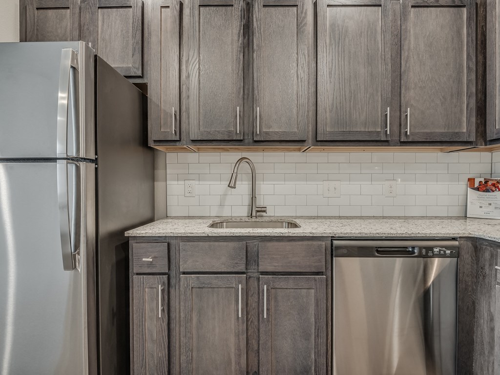 Kitchen with Dark Brown Cabinetry and Stainless Steel Appliances