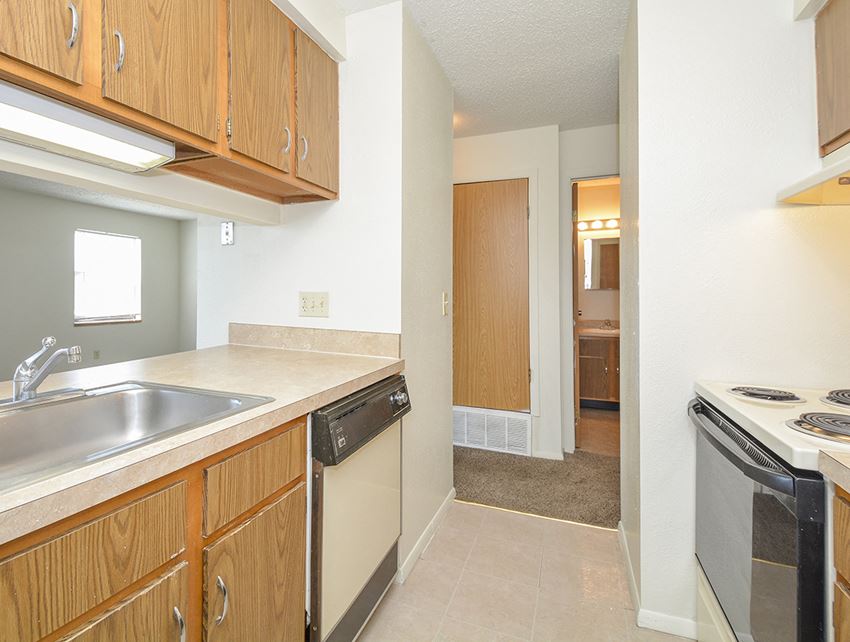 Fully-Equipped Kitchen Leads into Entryway Entryway of Apartment Kitchen - Photo Gallery