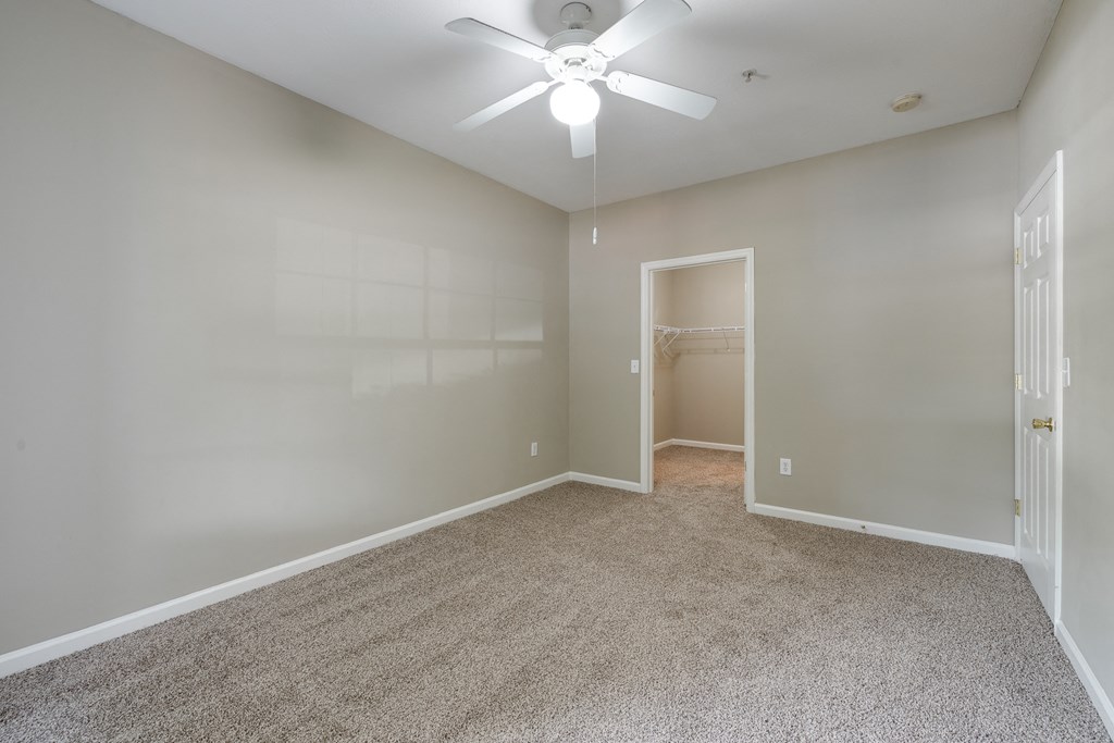 Carpeted Bedroom With Ceiling Fan & Light
