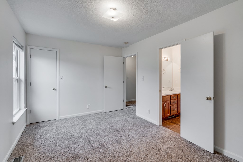 Bedroom Featuring Attached Bathroom & Closets