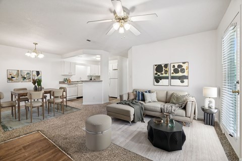 A living room with a grey couch and a wooden coffee table.