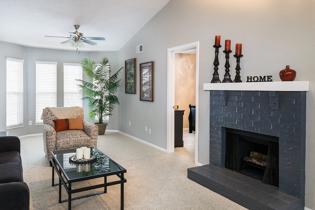 a living room with a fireplace and a couch