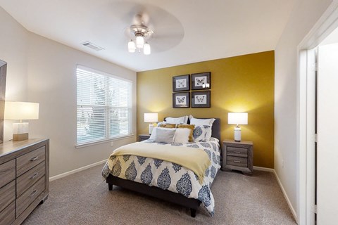 Spacious Bedroom with Large Double Windows and Ceiling Fan with Light