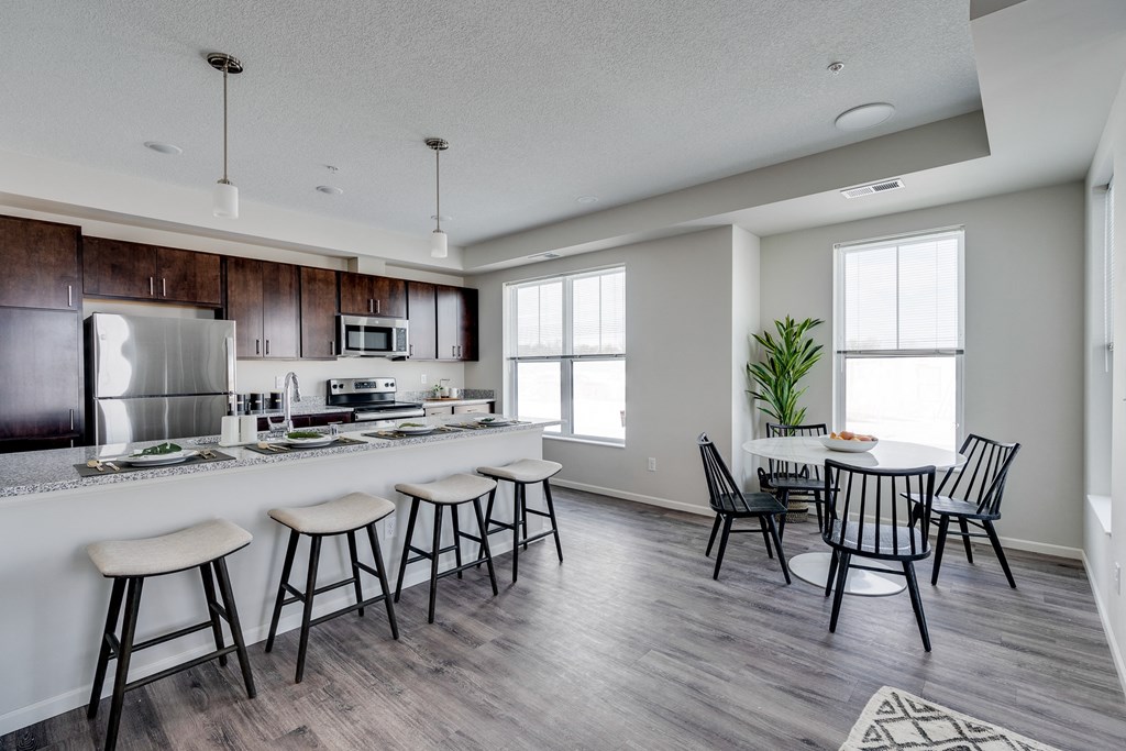 Expansive Granite Kitchen Island With Four Bar Stool Seats