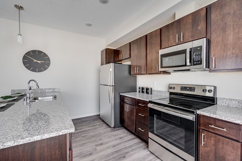 a kitchen with stainless steel appliances and granite counter tops